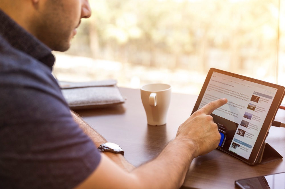 man using ipad for work